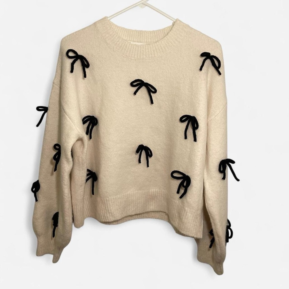 Elegant Cream Sweater with Black Bow Accents